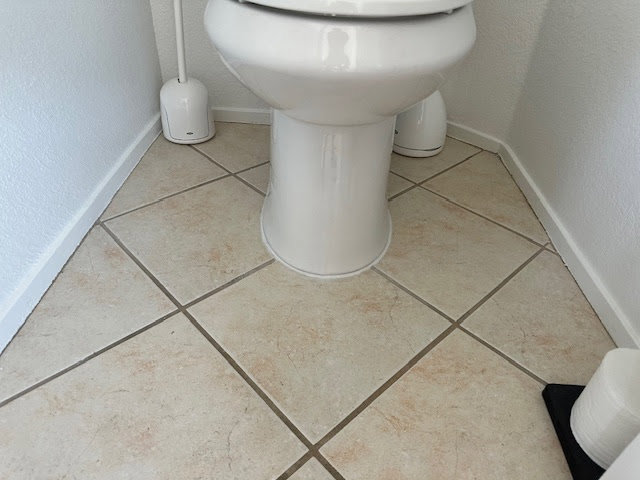 Fresh caulking around the base of a toilet on a tiled floor, completed by Henderson Handyman in Henderson, NV