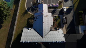 A top-down aerial view of a commercial roofing project in progress by First Choice Roofing in Cary, NC.