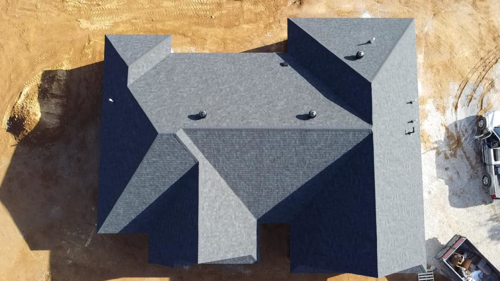 A top-down aerial view of a completed shingle roof with multiple vents installed by SJL Contracting, LLC in Owensboro, KY.