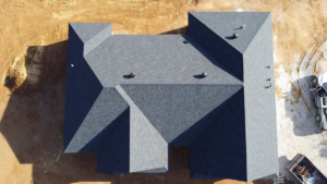 A top-down aerial view of a completed shingle roof with multiple vents installed by SJL Contracting, LLC in Owensboro, KY.