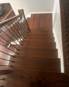Top-down view of a finished dark wood staircase with elegant balusters by International Wood Floors in Gaithersburg, MD