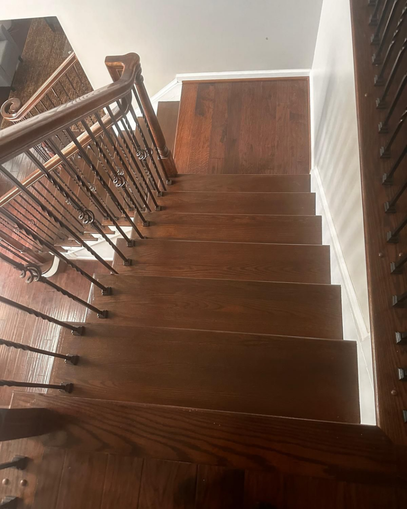 Top-down view of a finished dark wood staircase with elegant balusters by International Wood Floors in Gaithersburg, MD