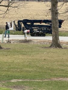 A tracked spider lift, specialized tree service equipment, parked on a roadside by SKV Tree Service in Morris, IL.