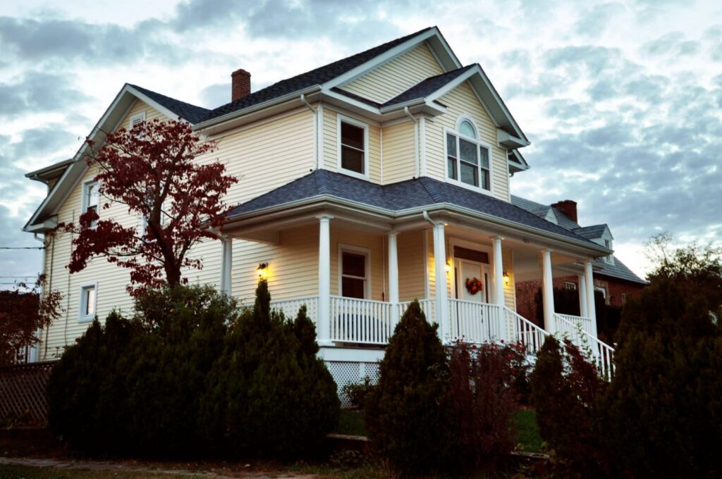 A renovated traditional home exterior with a welcoming porch by Dream Design Build & Remodeling, Inc. in Baltimore, MD