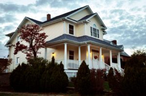 A renovated traditional home exterior with a welcoming porch by Dream Design Build & Remodeling, Inc. in Baltimore, MD