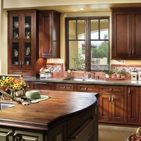 A beautifully remodeled traditional kitchen with dark wood cabinets and a large island by City Home Improvement Inc in Portland, OR.