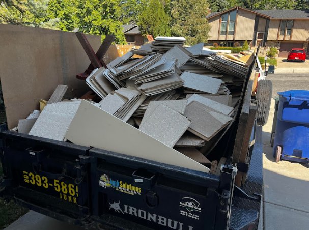 A Junk Solutions trailer filled with construction debris and old tiles, ready for removal in Ogden, UT.