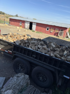 A trailer full of neatly cut firewood, ready for delivery or disposal by West Valley Tree Service LLC in Yakima, WA.