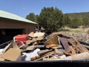 A Haul It All Services trailer full of construction debris and household items in Albuquerque, NM