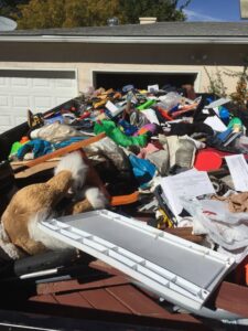 A Haul It All Services trailer full of various household items and debris in Albuquerque, NM