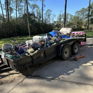 A trailer completely filled with various household junk and debris after a successful removal by Clutter Control Junk Removal and Demo in Biloxi, MS.