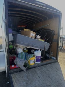 An enclosed trailer packed with various items of junk ready for removal by Junk Haulin Heroes in Bismarck, ND.