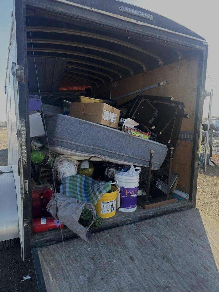 An enclosed trailer packed with various items of junk ready for removal by Junk Haulin Heroes in Bismarck, ND.