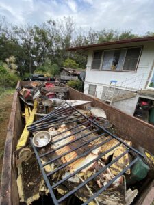 A large trailer filled with metal junk, old machinery, and various debris, ready for removal by EZ Pickups Hawaii LLC in Hilo, HI.