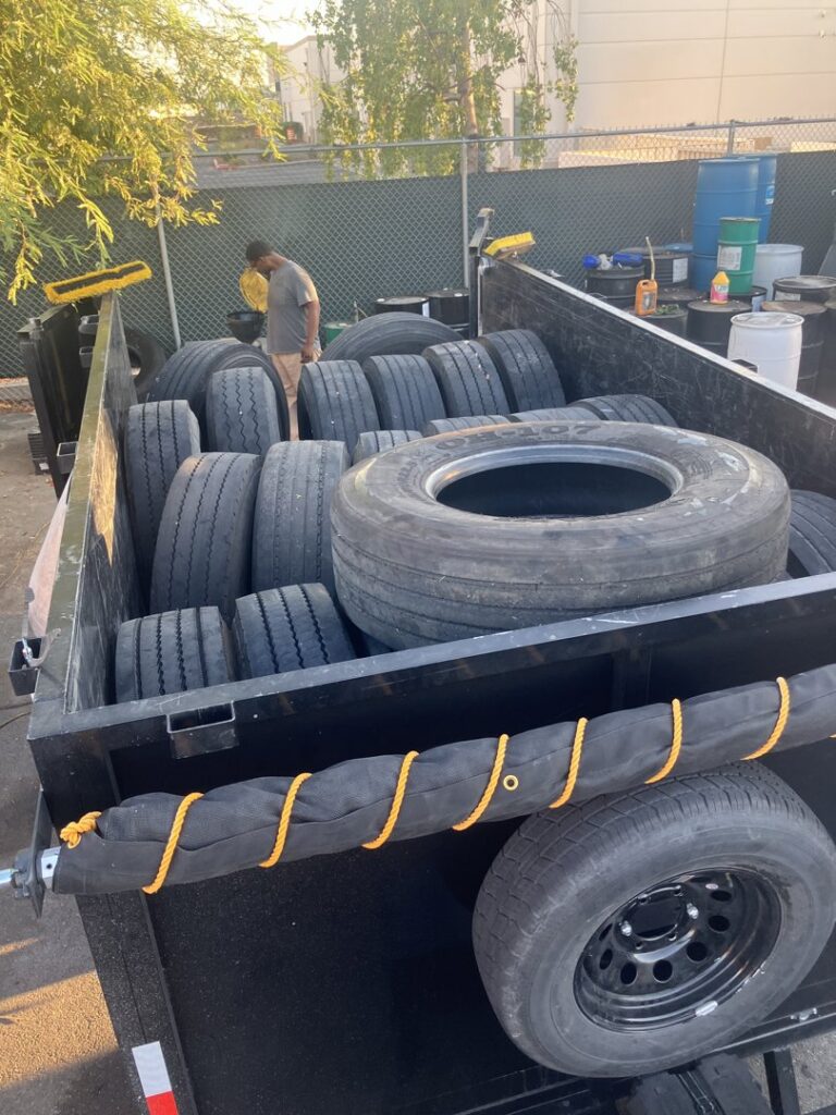 A utility trailer filled with numerous old tires ready for disposal by MGM Household Services in Las Vegas, NV.