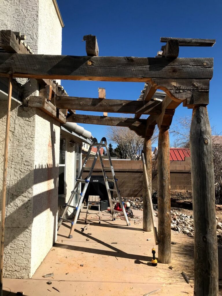 A Haul It All Services trailer full of branches, leaves, and a tree stump from yard waste removal in Albuquerque, NM