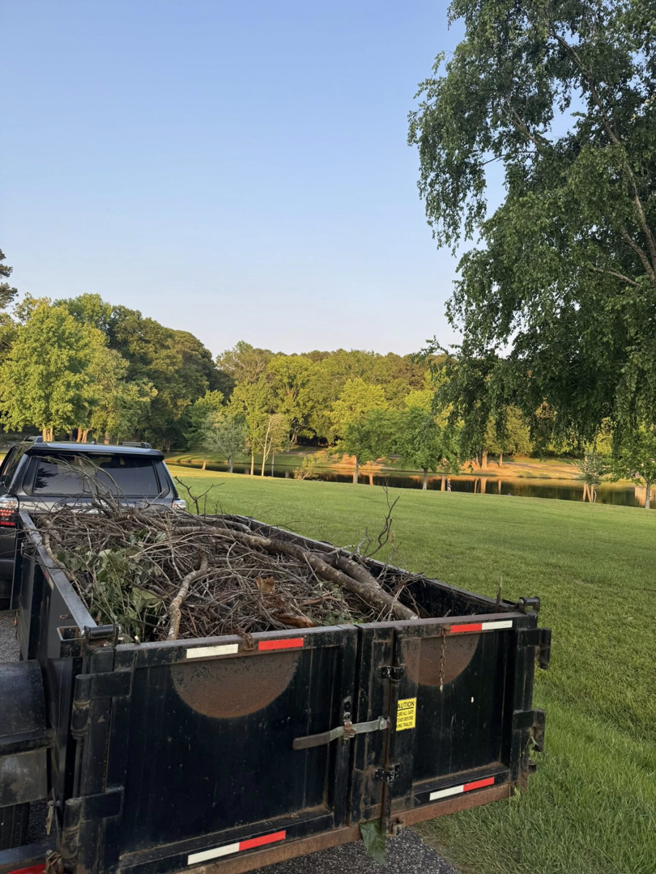 A trailer loaded with tree branches and wood debris, ready for hauling by JR's Rapid Junk Removal in Cary, NC