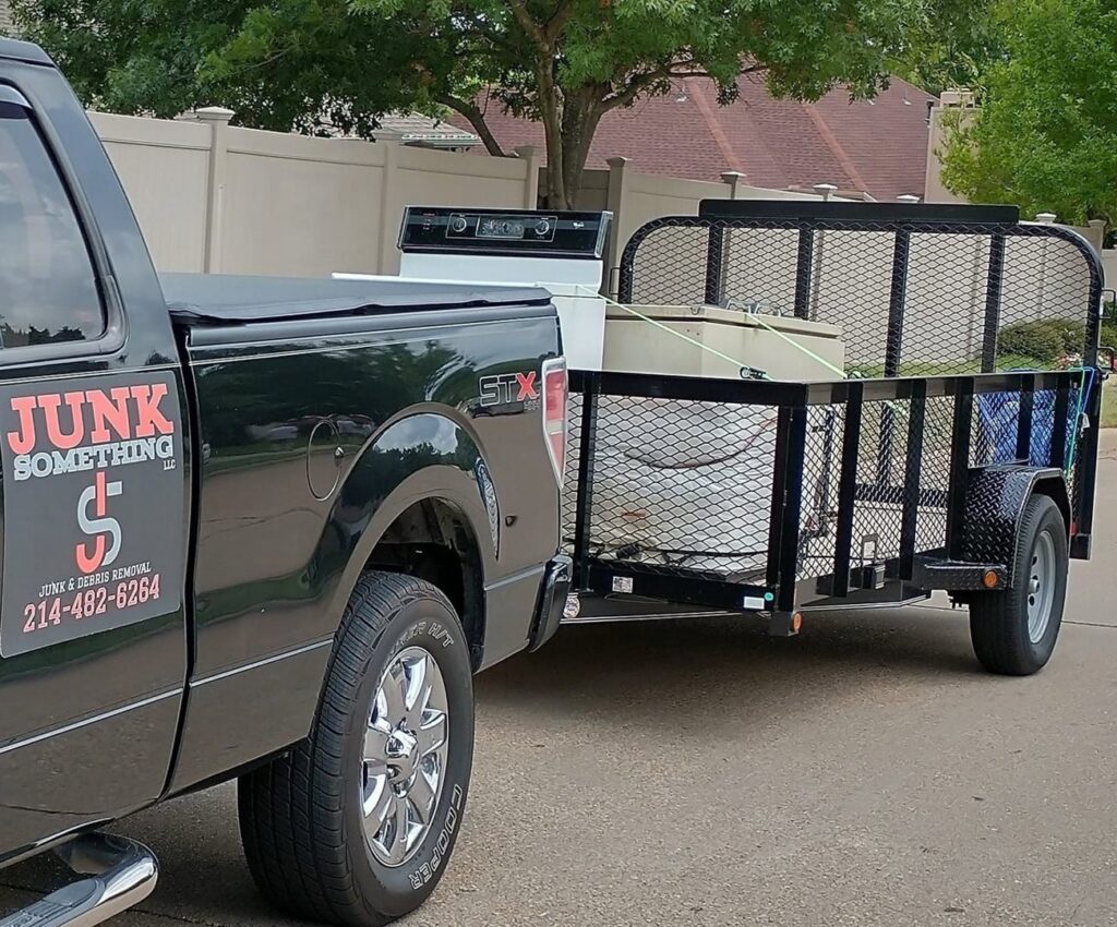 Inside view of a Junk Something llc trailer loaded with boxes and junk for removal in Dallas, TX.