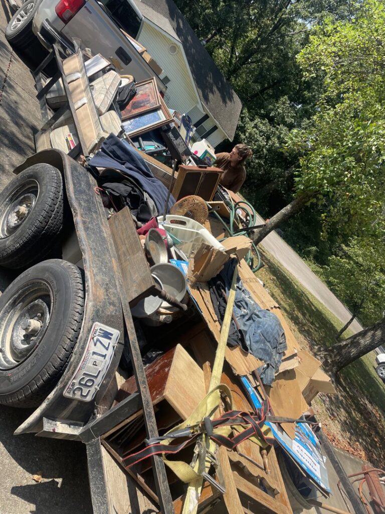 A trailer loaded with a variety of household junk and debris, ready for transport by DC'S Removal Service in Neelyville, MO.
