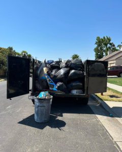 A trailer loaded with various household junk items and black bags by Fresno Hauling Heroes Junk Removal in Fresno, CA.