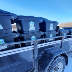 A trailer loaded with Big Lake Organics branded bins for organic waste collection in Ashland, WI.