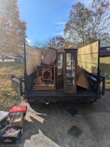 A trailer loaded with old wooden furniture and cabinets for removal by Junk Runner, LLC in East Berlin, PA.