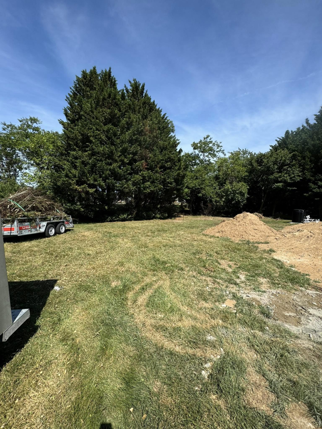 A trailer loaded with yard waste and debris for junk removal by DJ's Hauling & Junk Removal Services in Georgetown, DE.