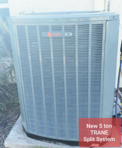 A Trane outdoor AC unit with gauges connected for service or installation by Rehabbing CASAS in Phoenix, AZ