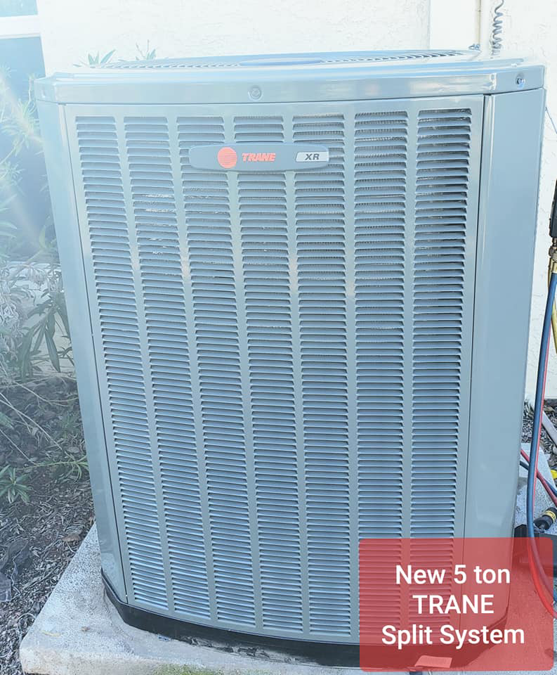 A Trane outdoor AC unit with gauges connected for service or installation by Rehabbing CASAS in Phoenix, AZ