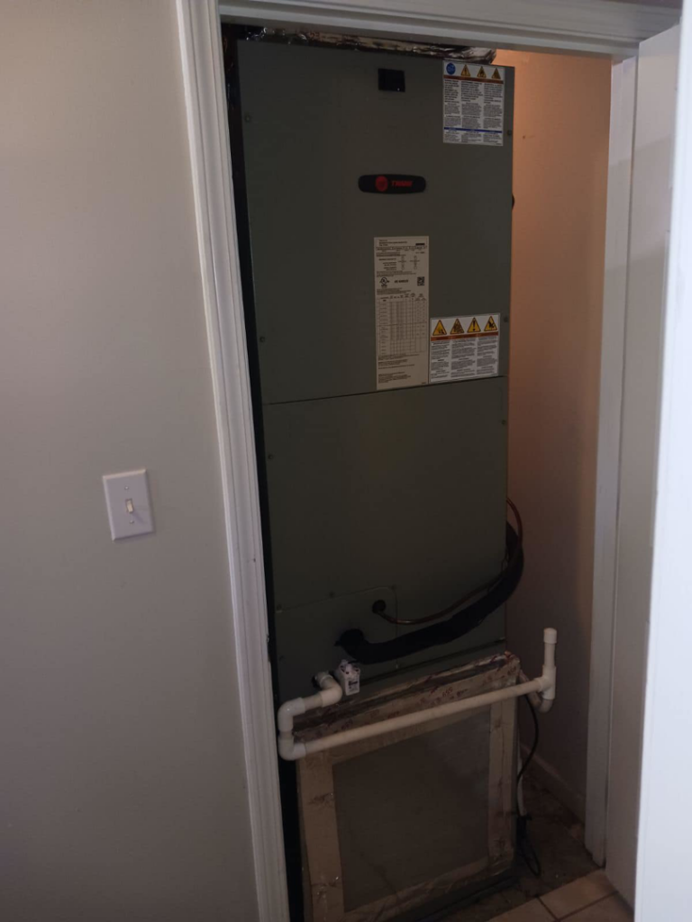 A Trane HVAC air handler unit installed in a utility closet by Stivers HVAC in Lexington, KY.