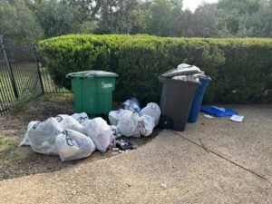 Multiple trash bags and loose items placed curbside for pickup by SATX Junk-A-Haulics in San Antonio, TX.