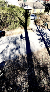 A large pile of tree debris and branches on the ground after tree trimming or removal by Hill's Tree Service in Norman, OK.