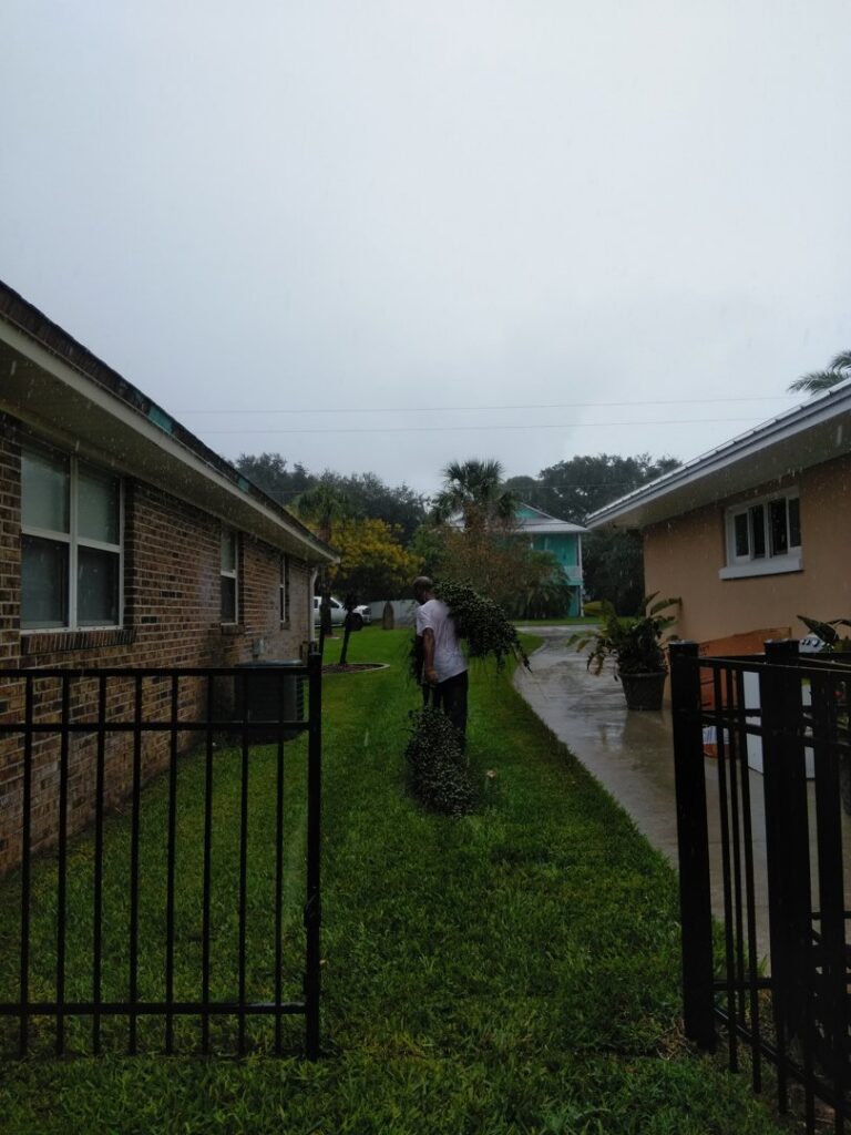 A Jesse James Tree Rangers crew member cleaning up tree debris after a service in Jacksonville, FL.