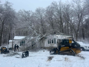 Hardin County Tree Service LLC Kentucky performing storm cleanup of a large tree fallen on a house in Elizabethtown, KY.