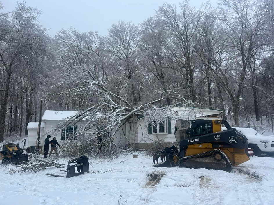 Hardin County Tree Service LLC Kentucky performing storm cleanup of a large tree fallen on a house in Elizabethtown, KY.
