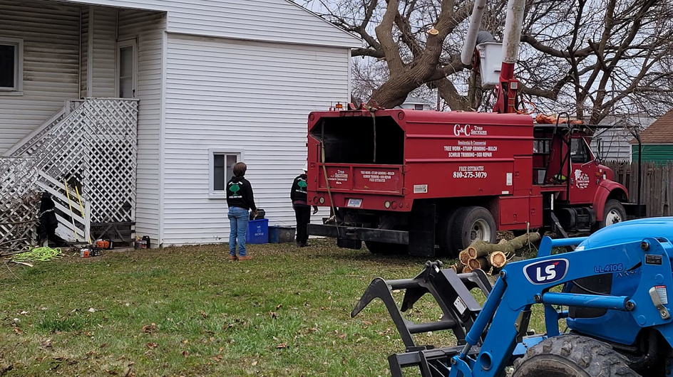 Arbor Tech Tree Specialist crew performing tree removal and chipping services in Flint, MI.