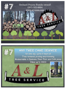 A&L Tree Service LLC team standing proudly in front of a large pile of logs after a tree removal job in Spokane, WA.