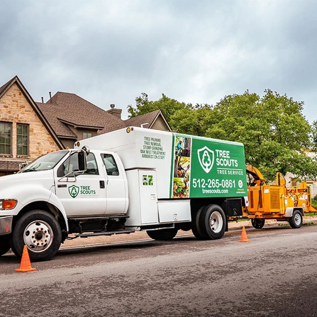 A Tree Scouts Tree Service & Trimming Georgetown branded truck with a wood chipper attached, ready for tree service jobs in Austin, TX.