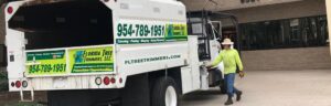 A branded tree service chipper truck ready for work by Florida Tree Cutters in Fort Lauderdale, FL