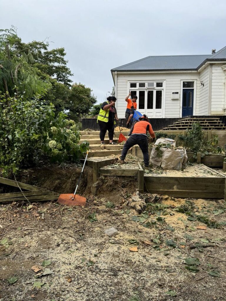 Tree service crew cleaning up wood chips and debris after tree work, provided by City Green Care Inc. in Honolulu, HI.