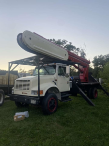 A large tree service crane truck used by 365 Trees in East Providence, RI.