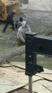 A tree service crew with a chipper and truck cleaning up after a tree removal by Hercules Tree Service in Akron, OH.