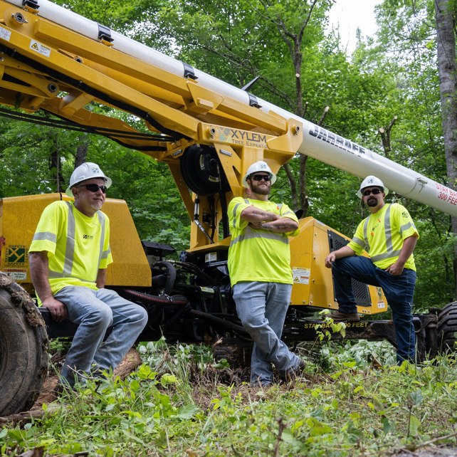 Tree service crew posing with a Jarraff tree trimming machine for Tree Care of New York in Alden, NY
