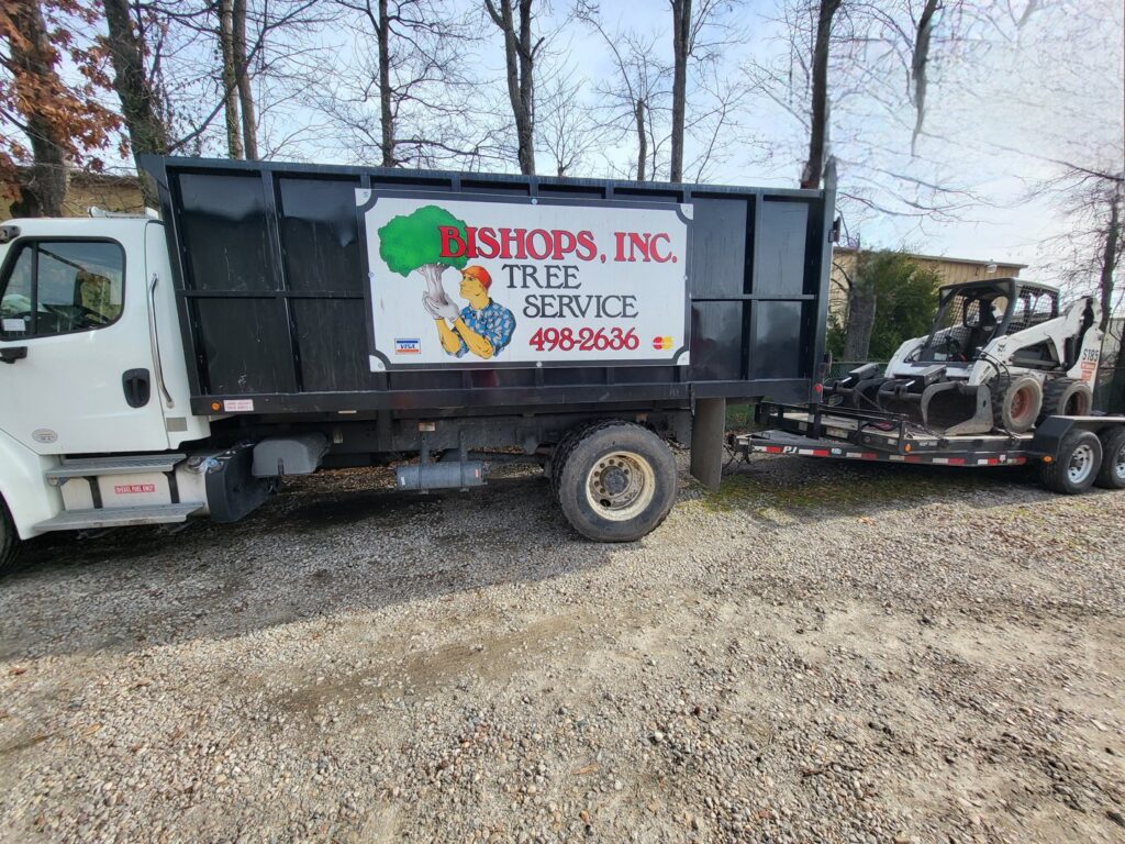 Bishops Tree Service Inc. branded dump truck and skid steer equipment in Virginia Beach, VA.