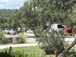 Tree service equipment including trucks and a wood chipper with crew members from S.A. Total Tree Service in San Antonio, TX