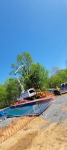 Tree service equipment near a construction site with a pool by Middle Tennessee Tree Service in Cookeville, TN.