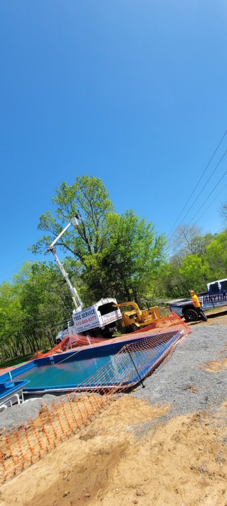 Tree service equipment near a construction site with a pool by Middle Tennessee Tree Service in Cookeville, TN.