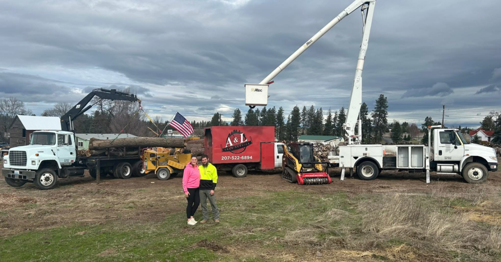 A&L Tree Service LLC team with heavy equipment including a crane truck, wood chipper, and bucket truck at a job site in Spokane, WA.