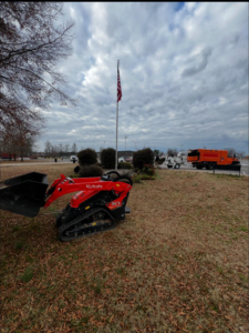A Kubota mini skid steer and a chipper truck ready for tree service work by Castle Tree Service in Conway, AR.