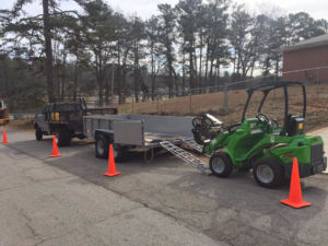 Tree service equipment including a truck, trailer, and loader ready for a job by Dad's Tree Care Inc. in Kirkwood, Atlanta, GA.
